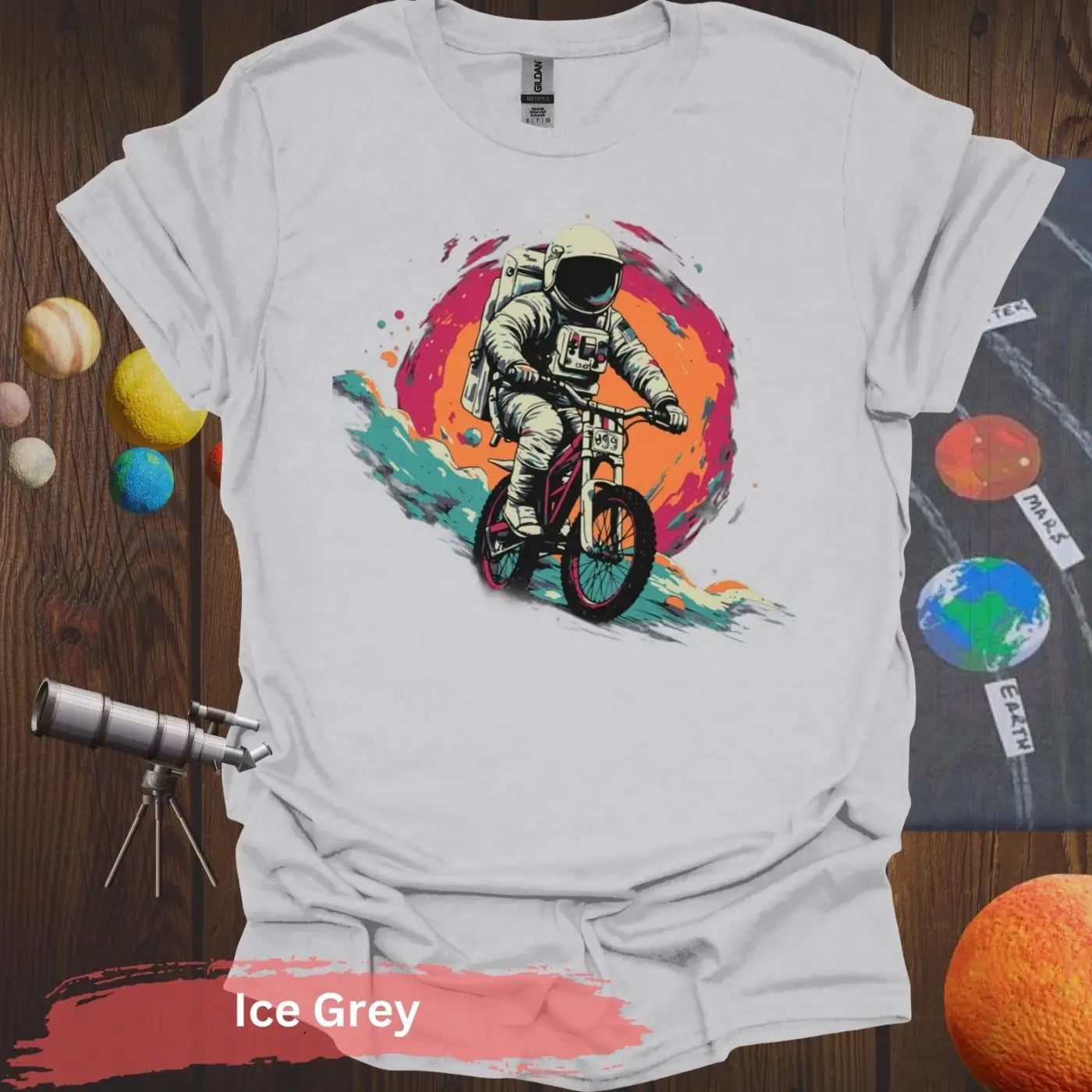 Cosmic Cyclist: Astronaut Biking Adventure T-Shirt - S - Unisex / Ice Grey - Physical Item