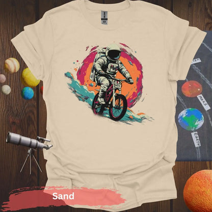 Cosmic Cyclist: Astronaut Biking Adventure T-Shirt - S - Unisex / Sand - Physical Item