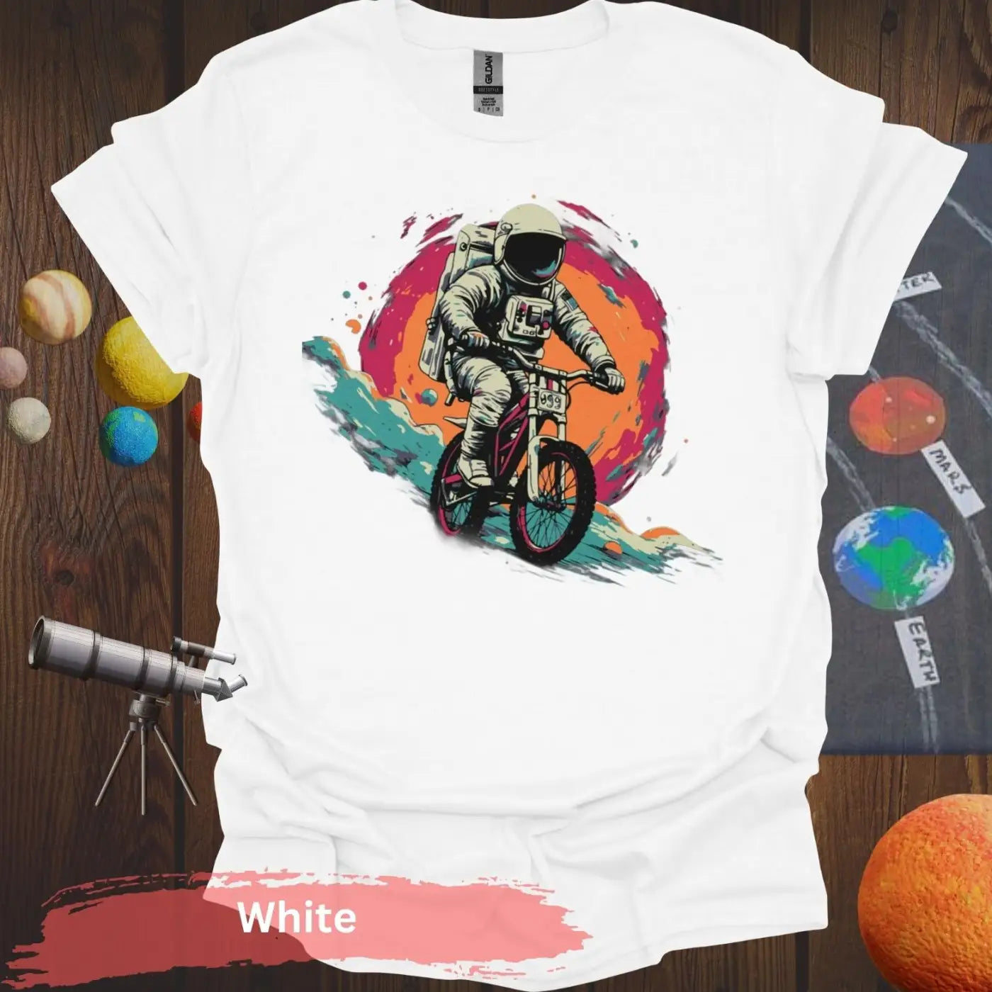 Cosmic Cyclist: Astronaut Biking Adventure T-Shirt - S - Unisex / White - Physical Item