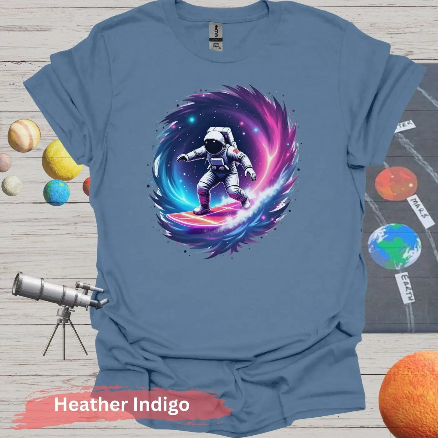 Cosmic Wave Rider – Astronaut Surfing Space Design T-shirt - S / Heather Indigo - Physical Item