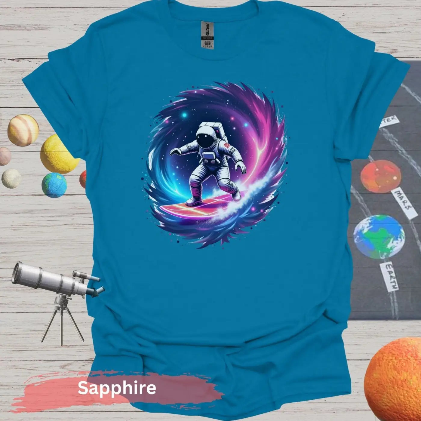 Cosmic Wave Rider – Astronaut Surfing Space Design T-shirt - S / Sapphire - Physical Item