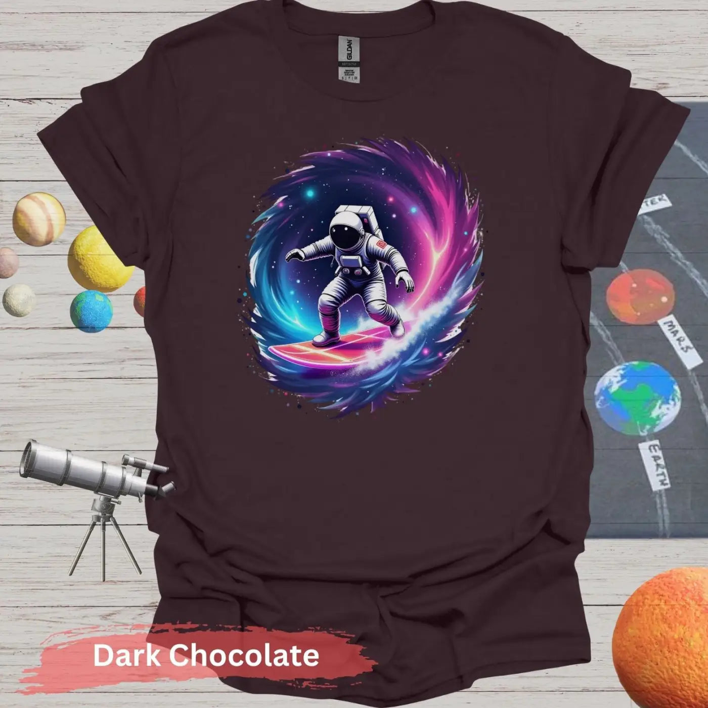 Cosmic Wave Rider – Astronaut Surfing Space Design T-shirt - S / Dark Chocolate - Physical Item