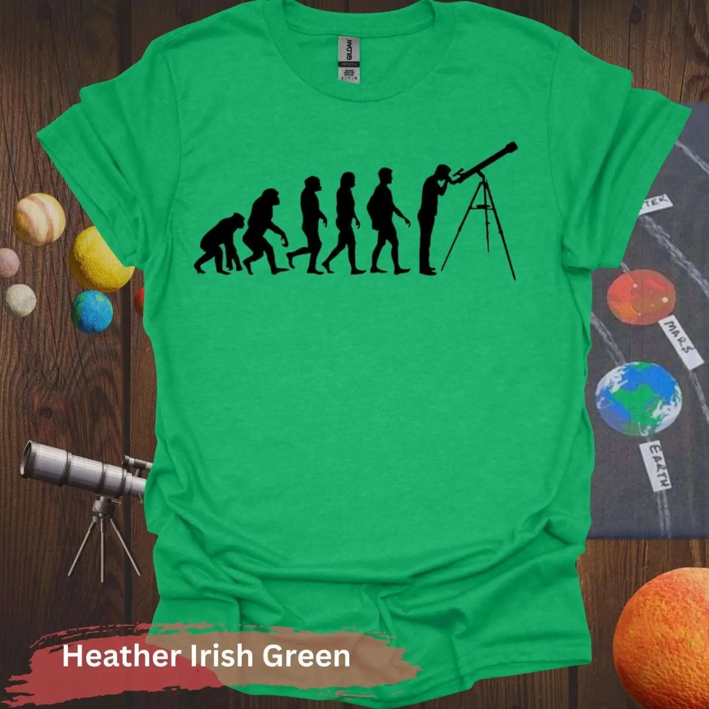 Evolution of Curiosity T-Shirt – From Ape to Stargazer - S / Heather Irish Green - Physical Item