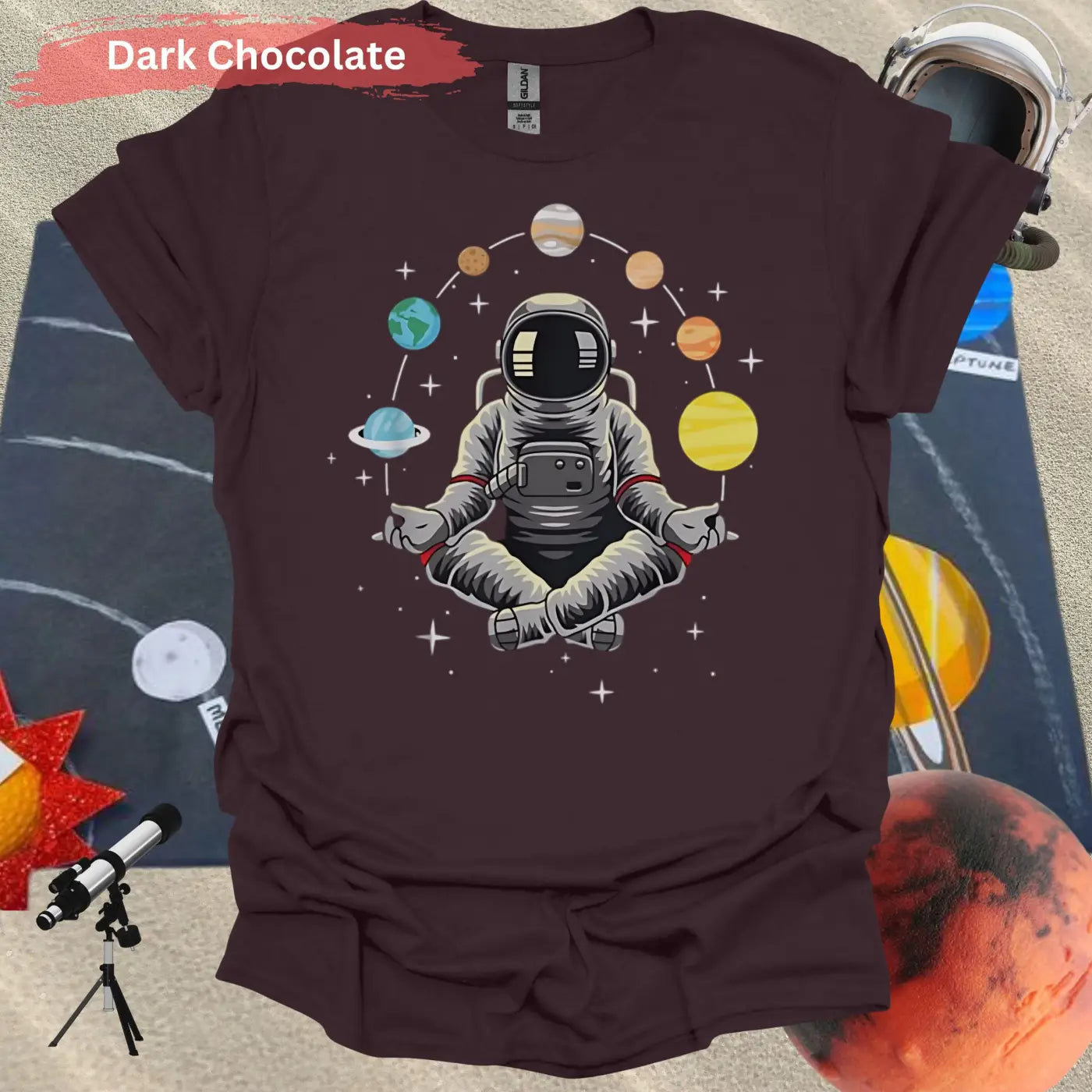 Meditating Astronaut Surrounded by Planets T-Shirt - S / Dark Chocolate - Physical Item