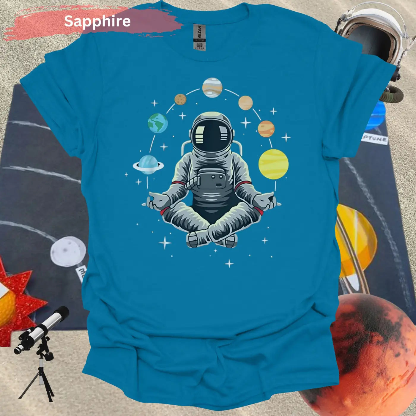 Meditating Astronaut Surrounded by Planets T-Shirt - S / Sapphire - Physical Item